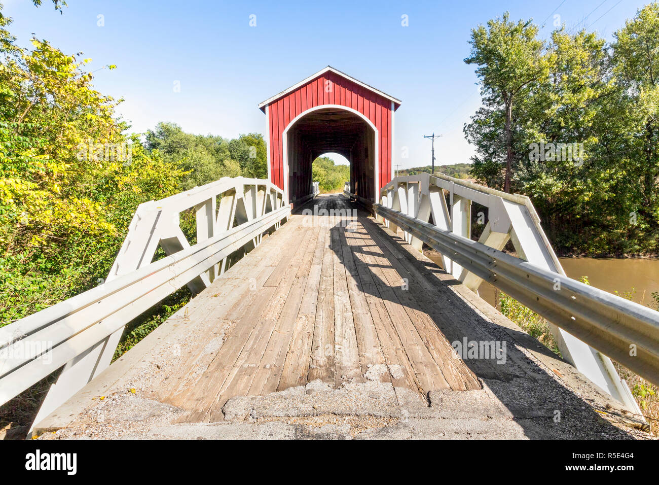 The red Wolf Covered Bridge, with pony truss approaches, crosses the