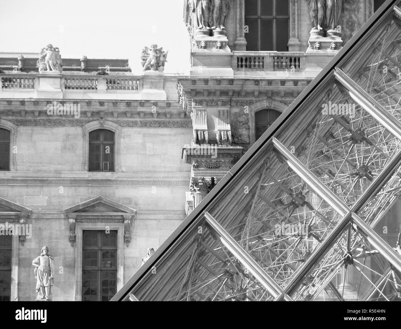 The Palais du Louvre, Paris, France: the Pyramid in the centre of the Cour Napoleon and the Pavillon Denon beyond. Black and white version Stock Photo