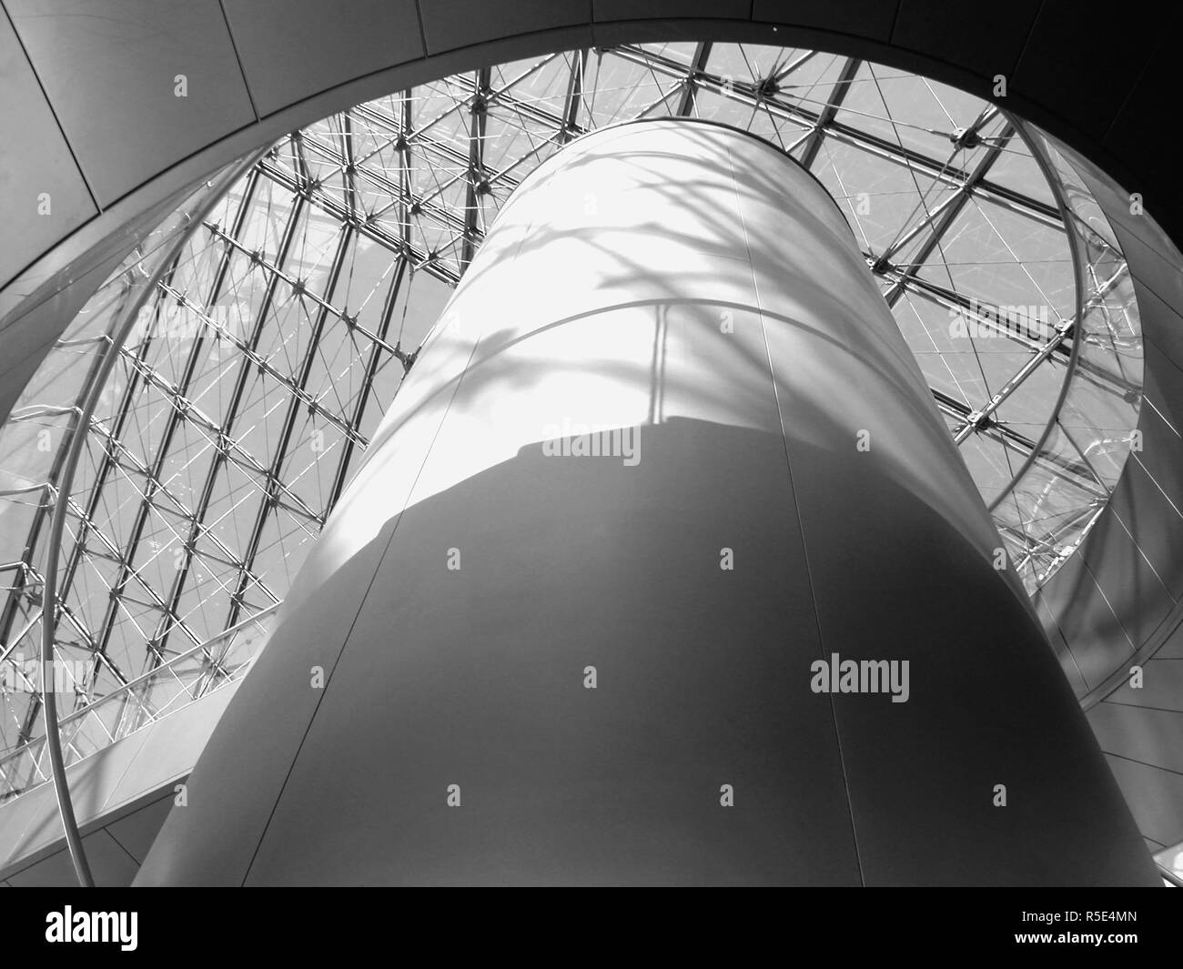 Inside the Pyramid, Musée du Louvre, Paris, France:  looking up towards the glass roof. Black and white version Stock Photo