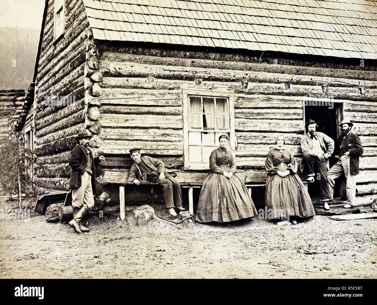 Frontier family outside their log cabin in rural British Columbia ca. 1867  or 1868 Credit: UBC Library Stock Photo - Alamy