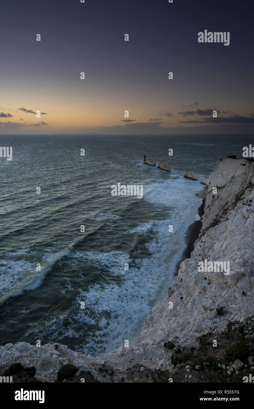 A cold and windy November evening at sunset at the Needles lighthouse on the Isle of Wight after the recent stormy weather. Rough seas prevail and the Stock Photo