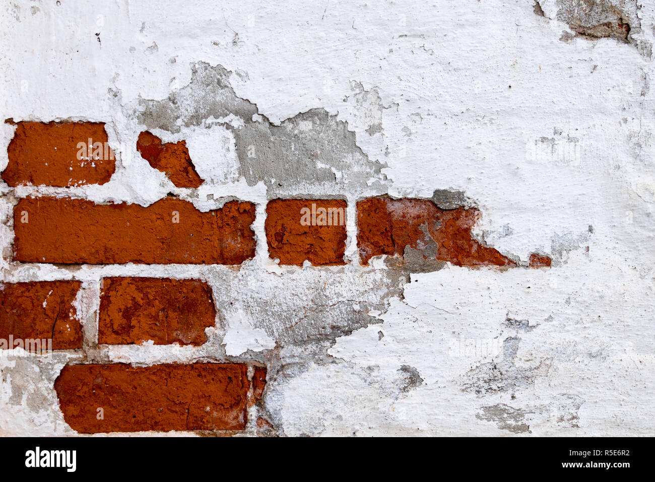 Exposed brick wall. White paint. Stock Photo