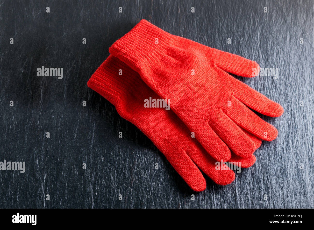 Red gloves on black background Stock Photo - Alamy