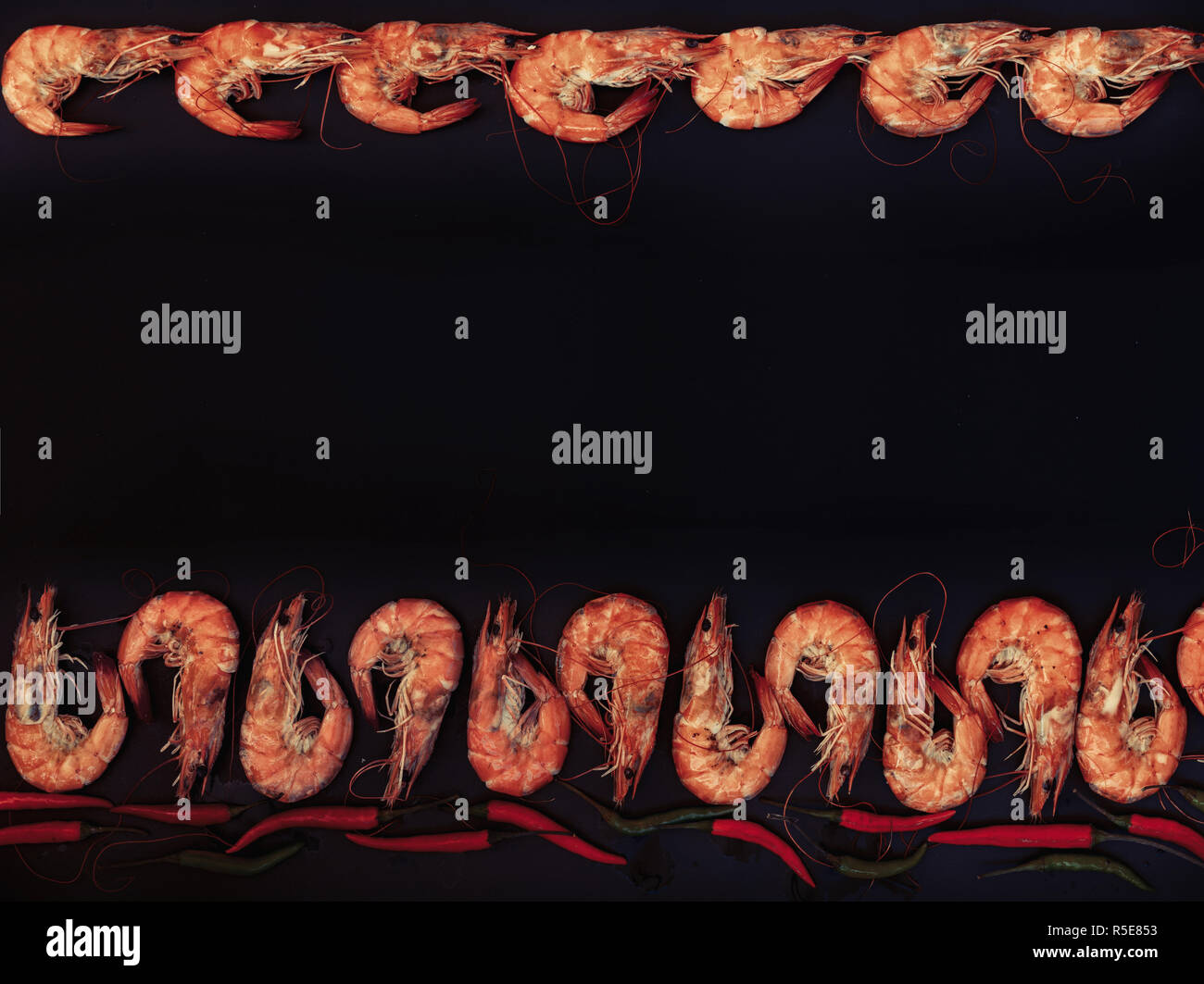 Perfect cooked prawns shrimps with herbs, spices and text space note