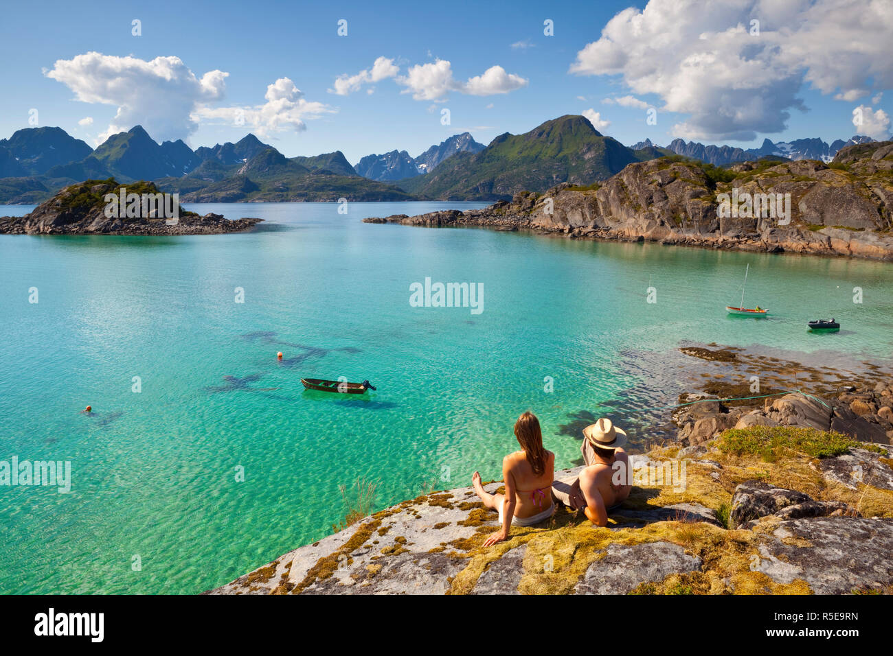 A couple take in the dramatic coastal landscapes near Raftsundet, Lofoten, Nordland, Norway (MR) Stock Photo