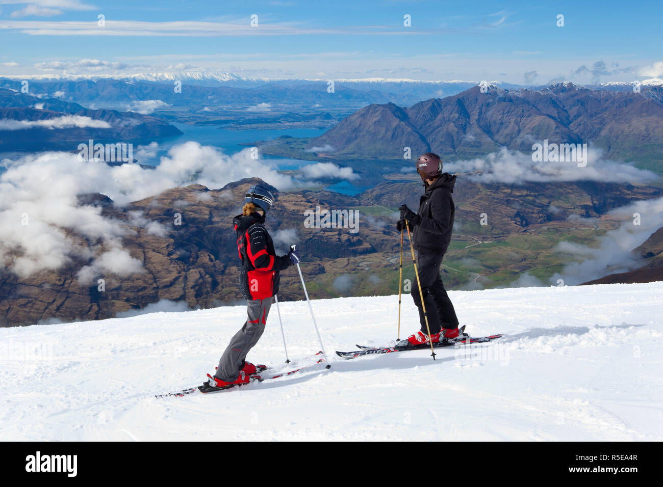 Skiiers take in the majestic vistas from Treble Cone, Wanaka, Central Otago, South Island, New Zealand Stock Photo