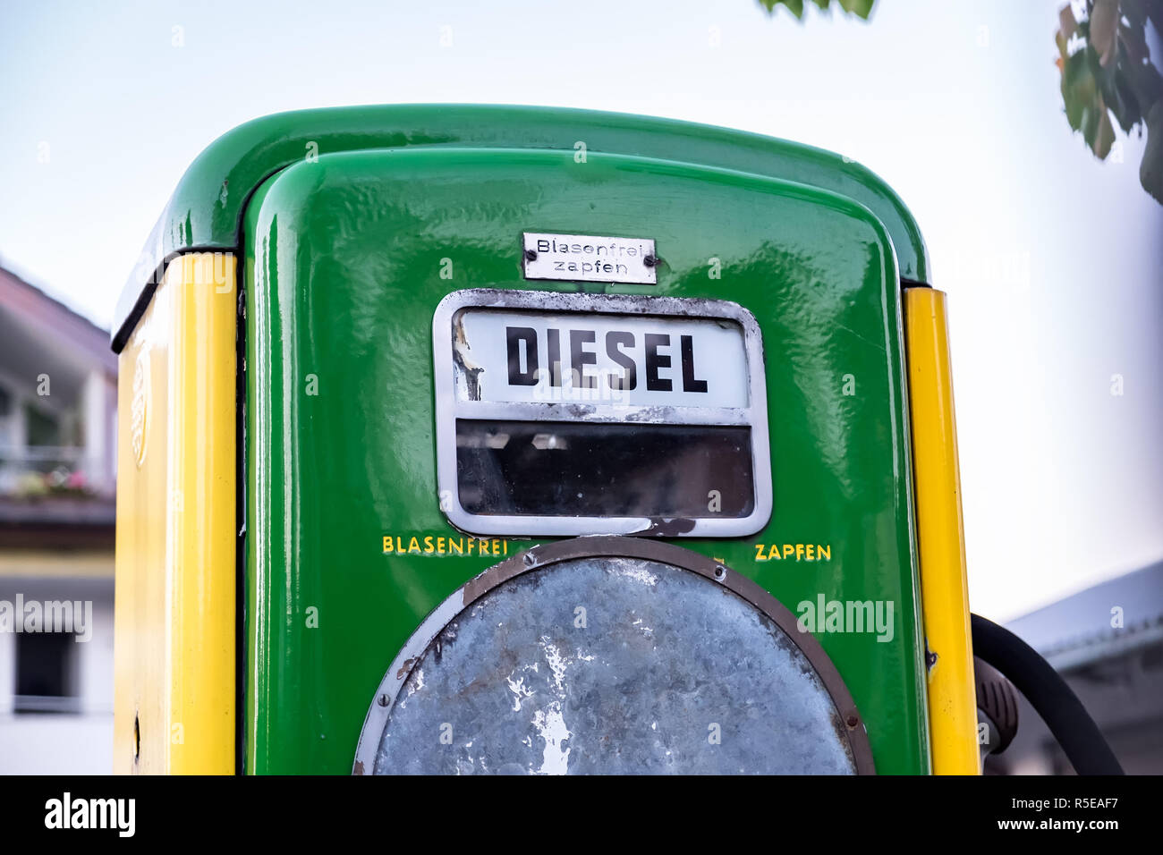 Historic green and yellow fuel dispenser for diesel petrol with German text 'Blasenfrei zapfen' (engl. Refuel without bubbles) Stock Photo