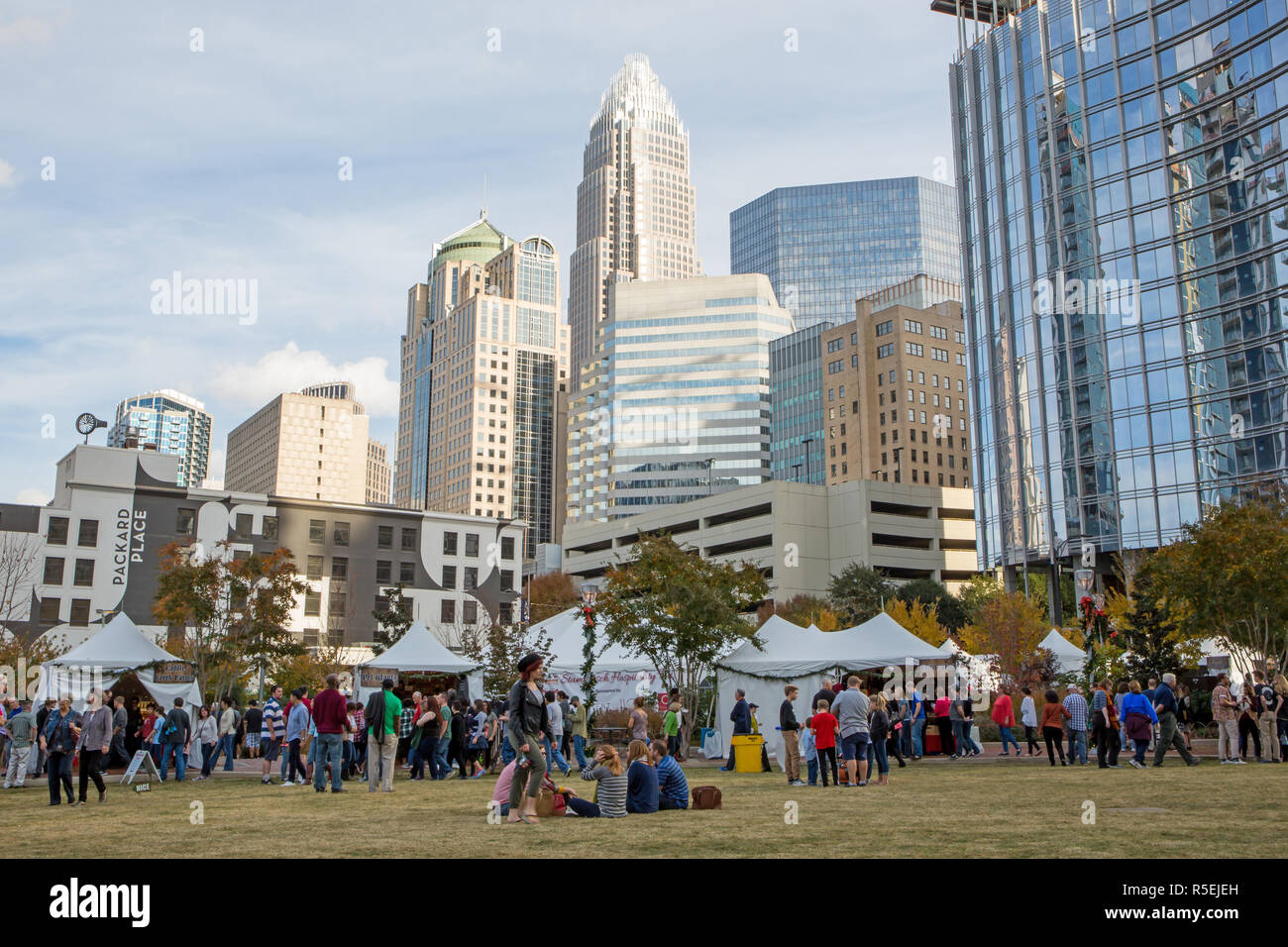 CHARLOTTE, NC - November 25, 2016:  People gather to enjoy a warn day in Romare Bearden Park in Uptown Charlotte, North Carolina. Stock Photo