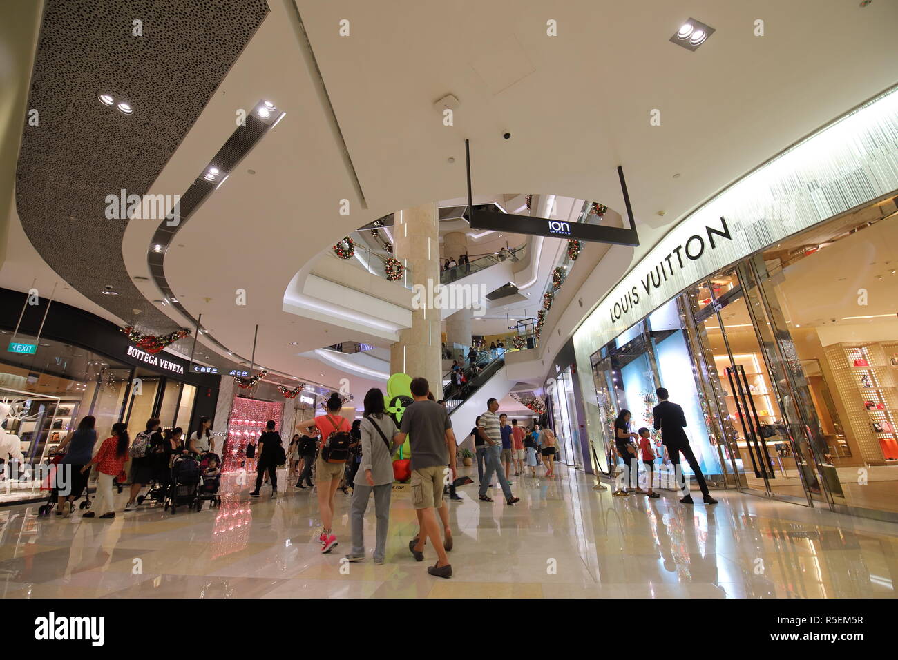 People visit ION Orchard shopping mall in Orchard road Singapore Stock