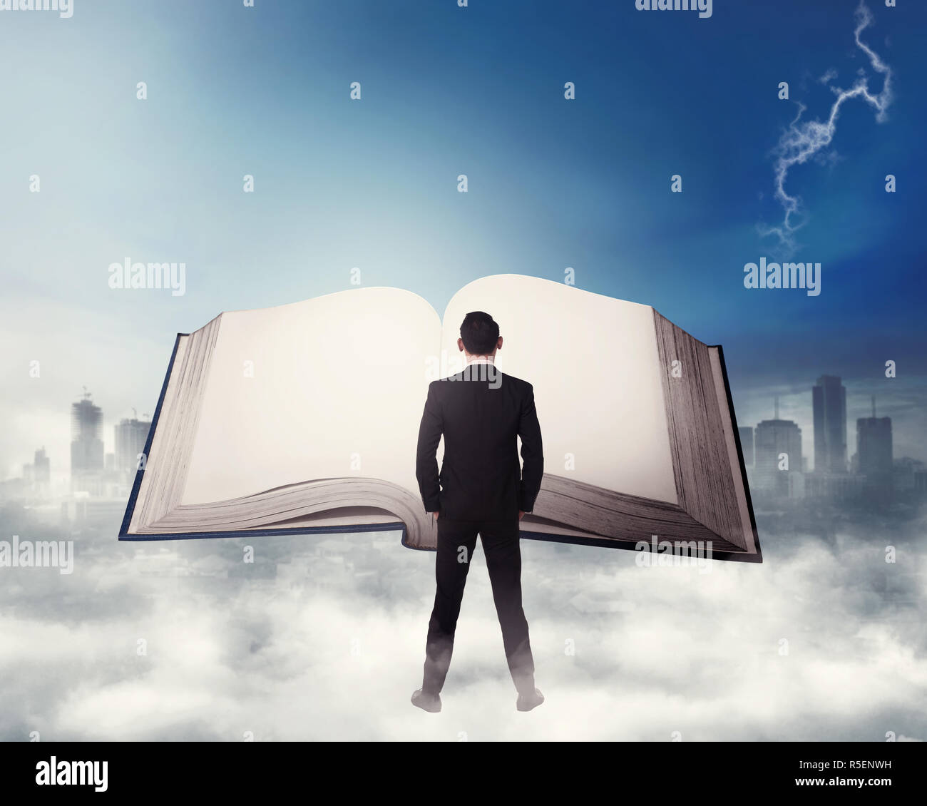 Young business man reading big book Stock Photo