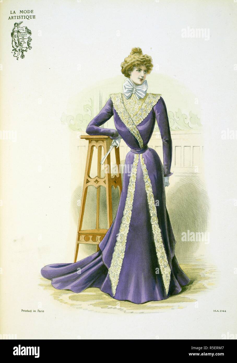 '...A graceful indoor toilette of grape-coloured velvet created by the Maison Honnet for the Comtesse de Ravenal. The skirt ... is cut up the front into a double tunic which falls in long points and is edged with guipre de Venise... At the thoat is a dainty cravat of tulle, clasped with a diamond buckle. This model is the real robe d'intÃ©rieur as distinct from the tea-gown with which it is often confounded. . The Powder Puff [An English edition of 'La Mode artistique'.; 1898]. (London, England : 1898). Source: The Powder Puff. Christmas, plate 244. Stock Photo