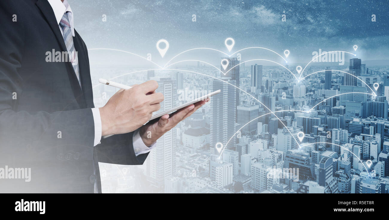 Double exposure businessman using digital tablet, and cityscape. Business network, blockchain technology and internet connection Stock Photo