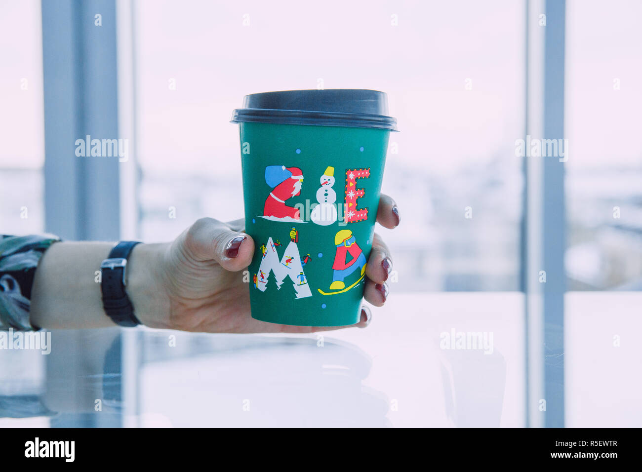 City Riga, Latvia. Coffe plastic green cup and glass table. Travel ...