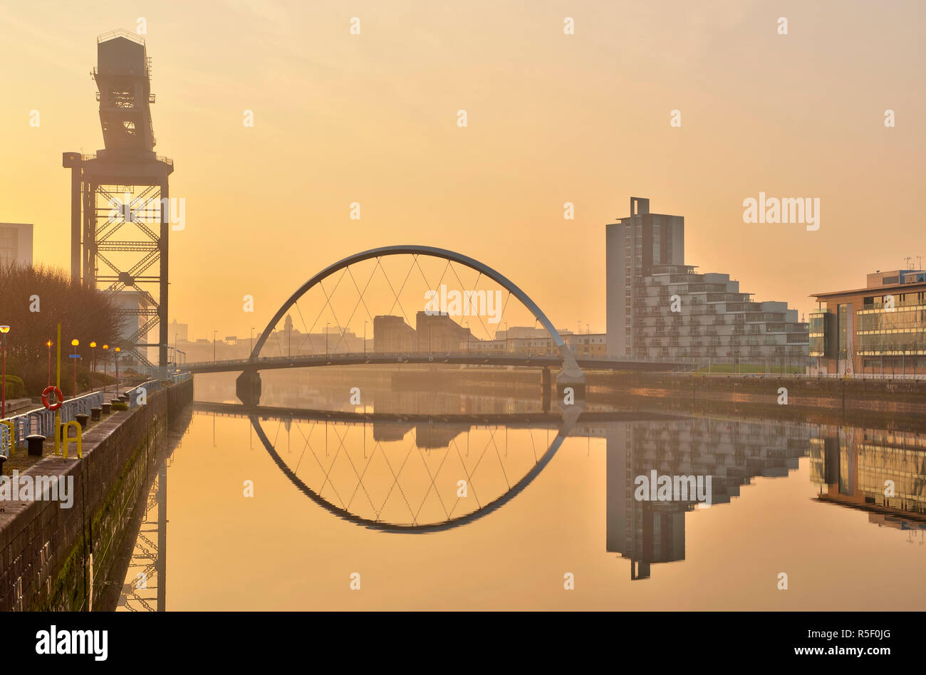 UK, Scotland, Glasgow, River Clyde, Finnieston Crane and the Clyde Arc, nicknamed the Squinty Bridge Stock Photo