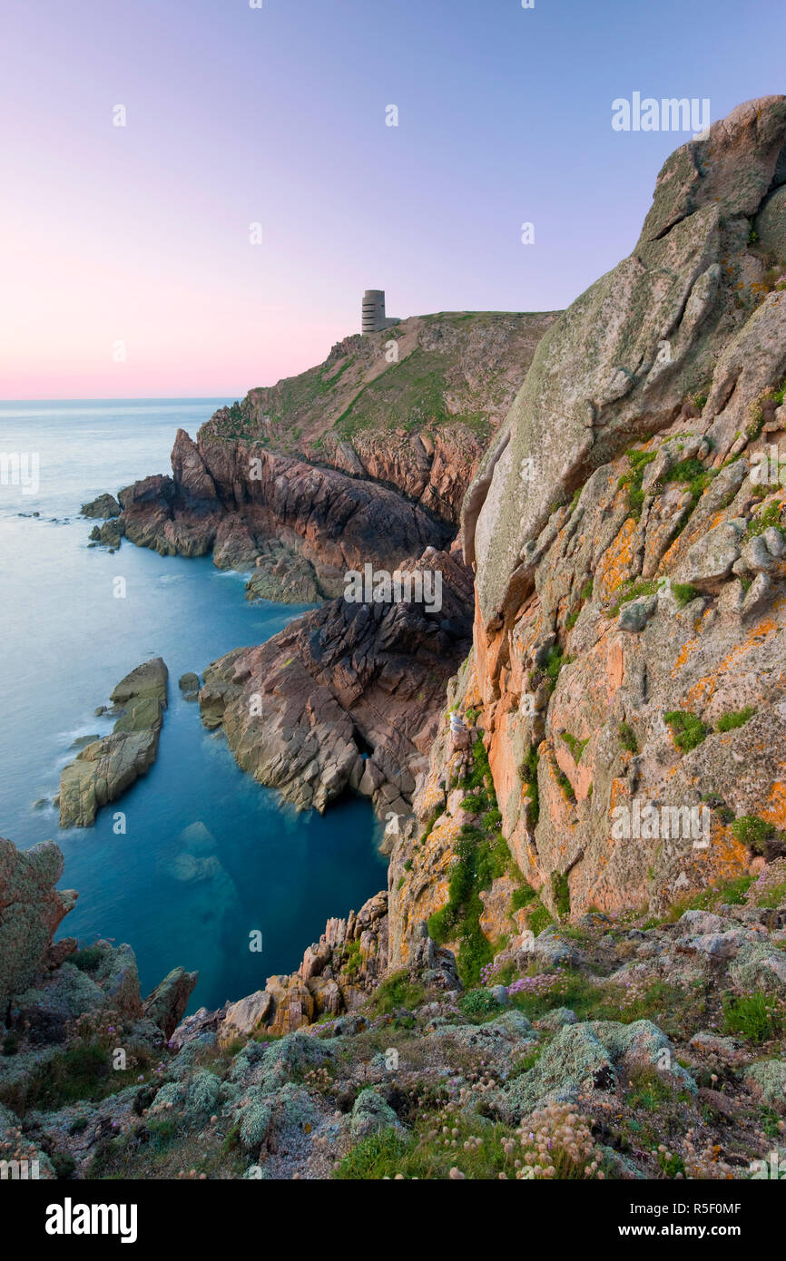 WWII German Observation tower and the rocky northwest coastline of Jersey, Channel Islands, UK Stock Photo