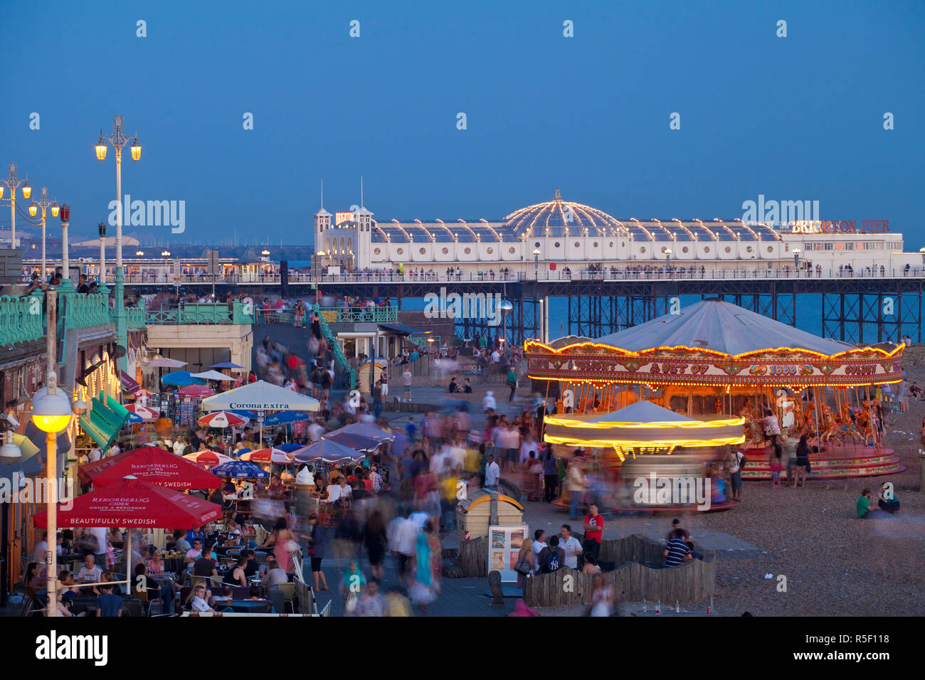 United Kingdom, England, Carousels on Brighton beachfront at twilight Stock Photo