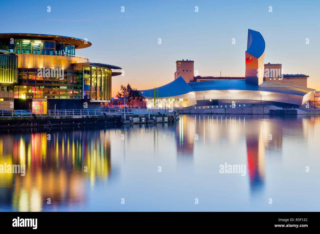 UK, England, Greater Manchester, Salford, Salford Quays, Imperial War Museum North with The Lowry's Quays Theatre on left Stock Photo