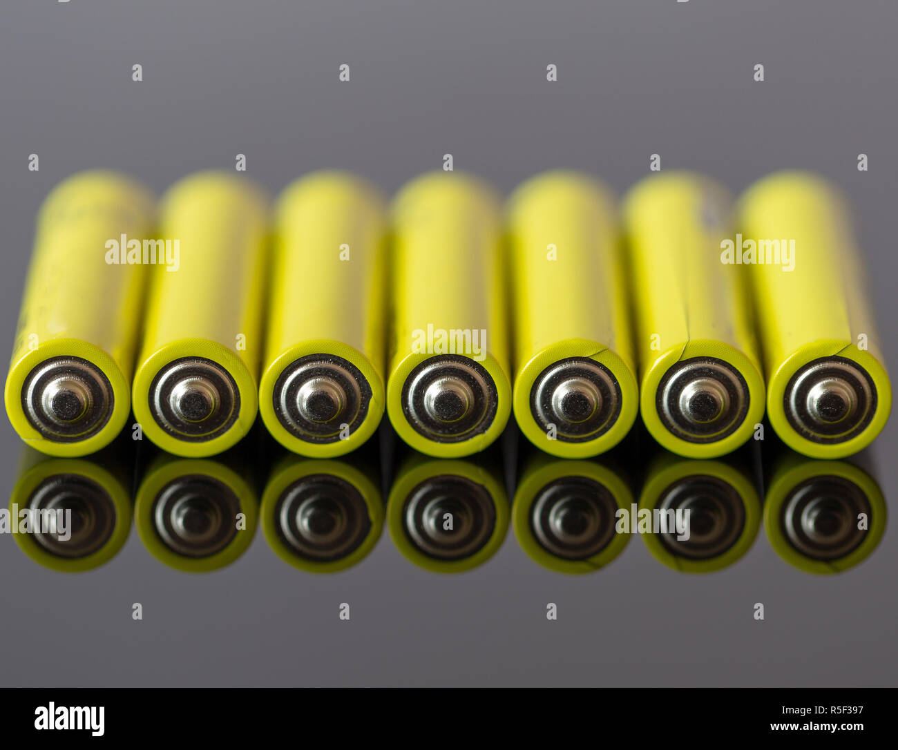 Energy Abstract Background Of Yellow Color Batteries. Mirror Effect