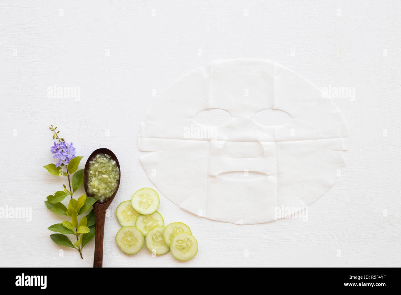 natural sheet mask for aroma skin face from herbal cucumber essence face mask on background white Stock Photo