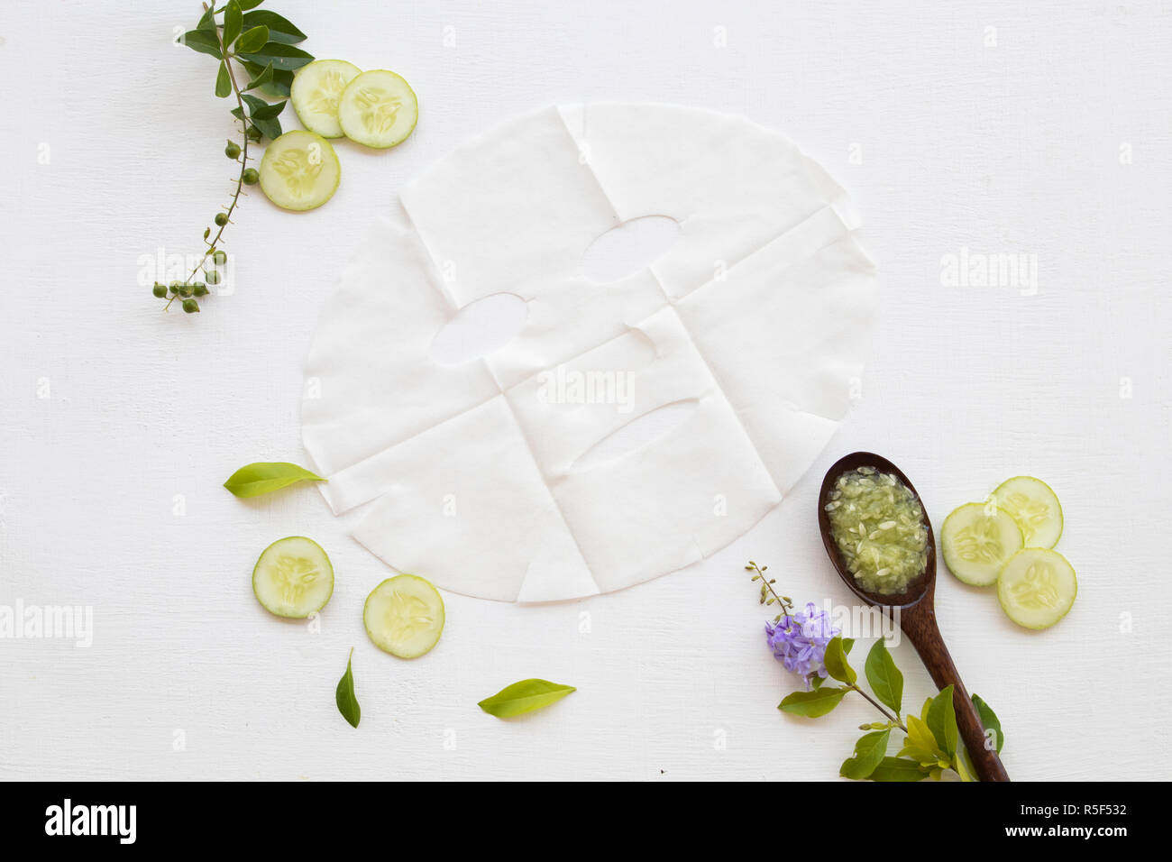 natural sheet mask for aroma skin face from herbal cucumber essence face mask on background white Stock Photo