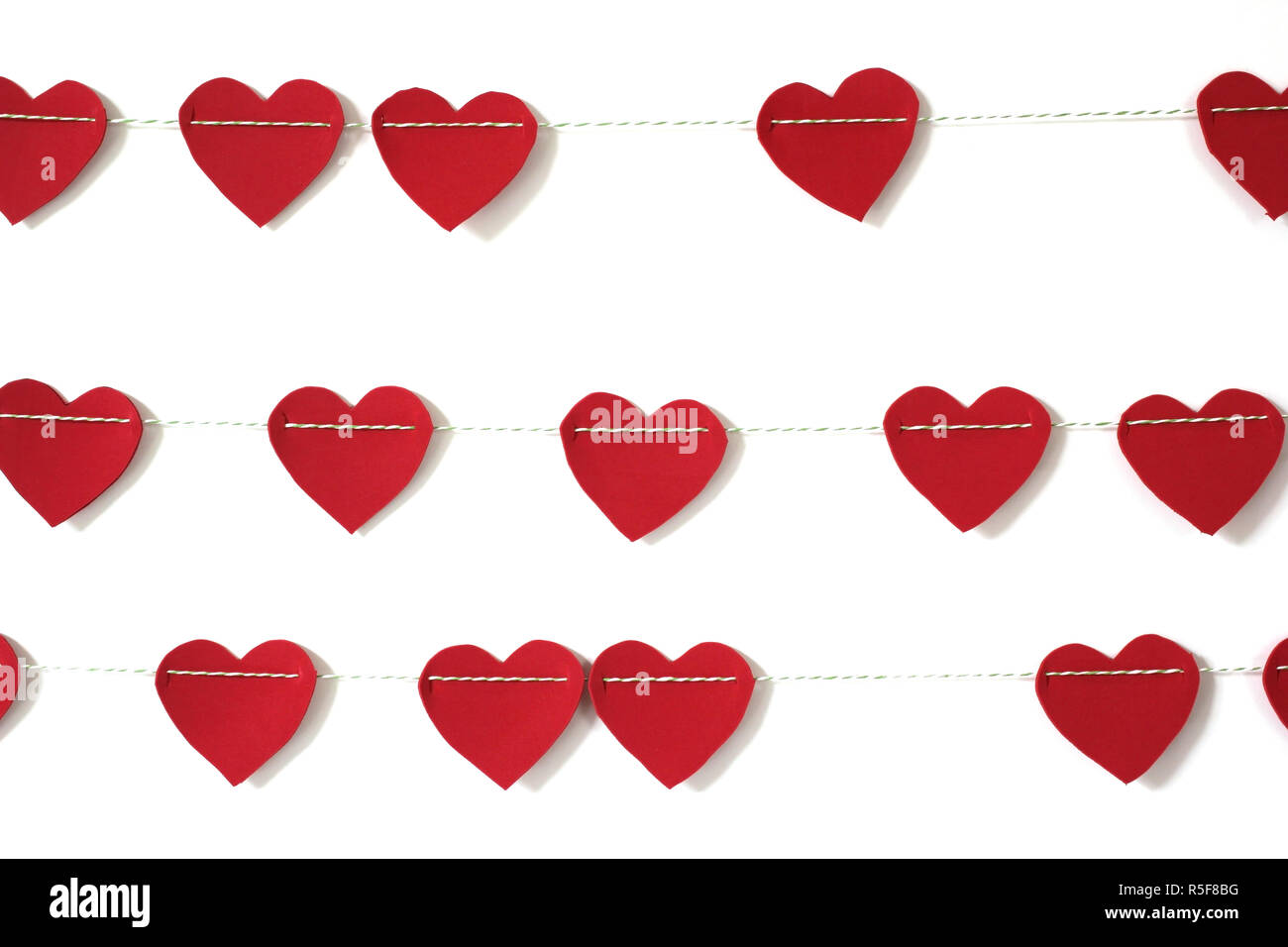 red paper heart hanging on the clothesline. on white background Stock ...