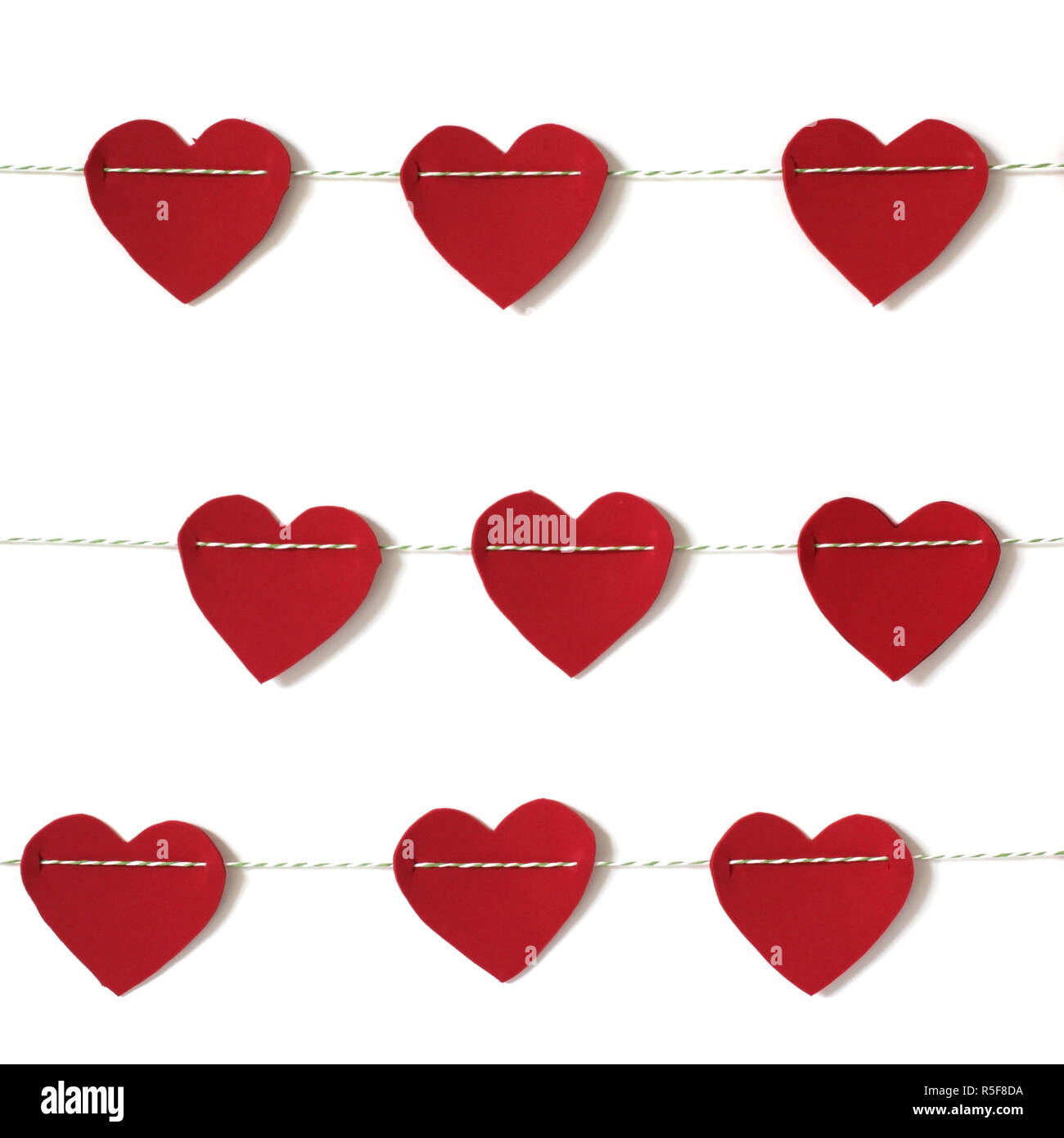 red paper heart hanging on the clothesline. on white background Stock ...