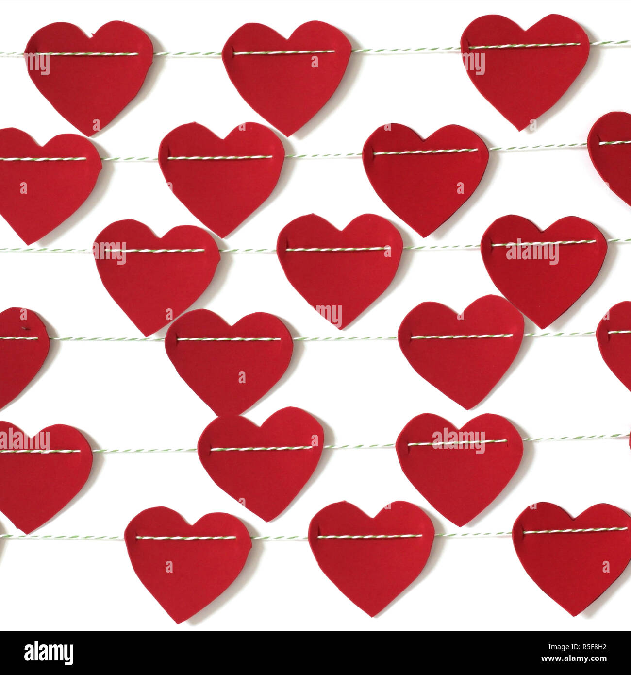 red paper heart hanging on the clothesline. on white background Stock ...