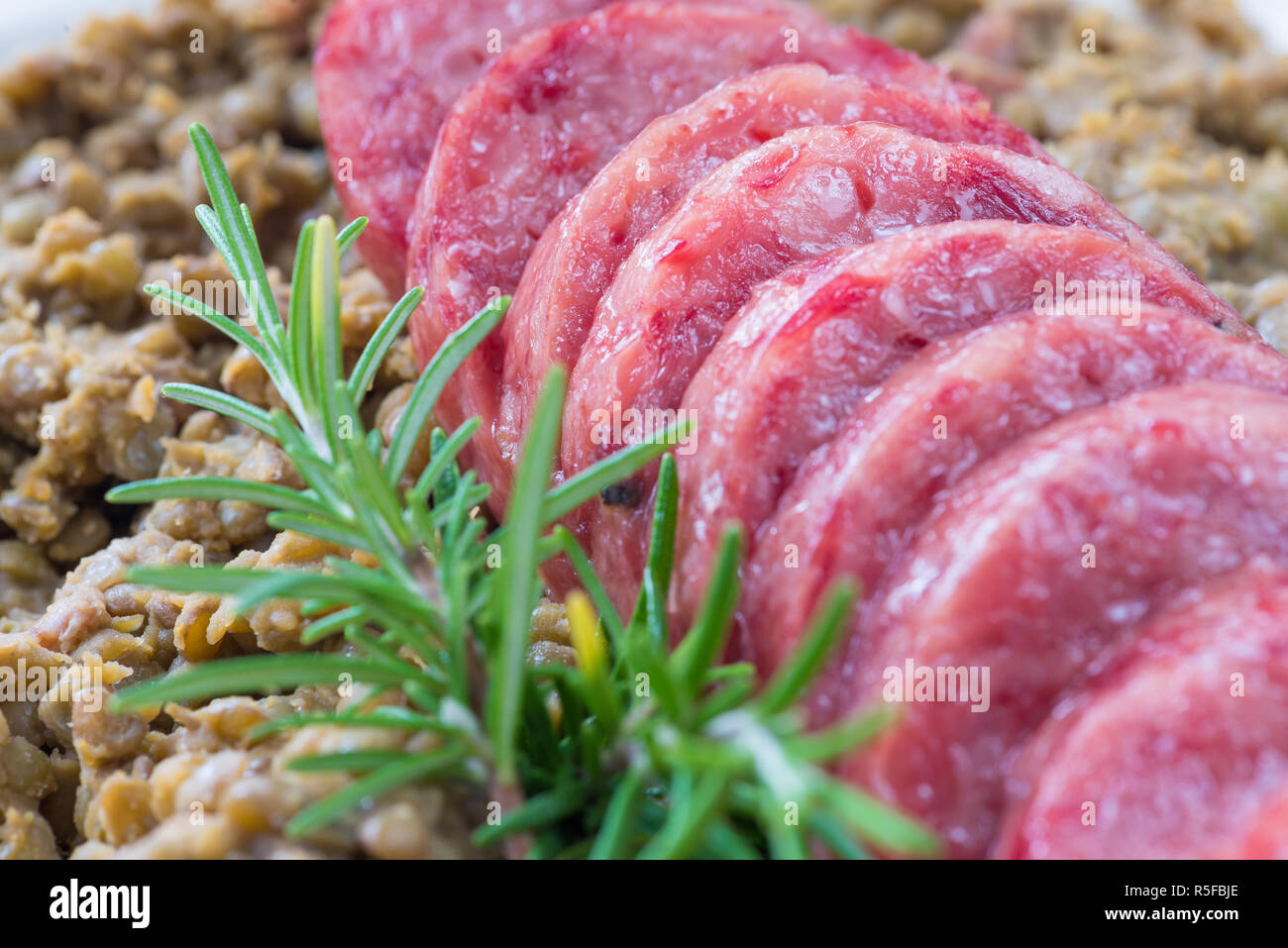 Cotechino (pork sausage) with lentils. Traditional Italian food Stock Photo