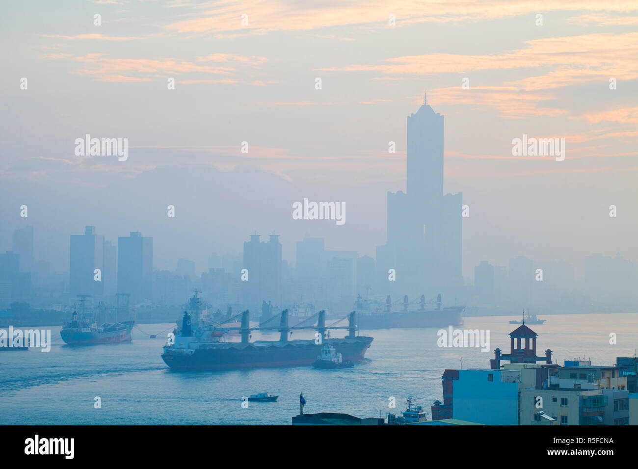 Taiwan, Kaohsiung, View of Cijin and harbour looking towards the city and  Kaoshiung 85 Sky Tower - Tunex Sky Tower Stock Photo