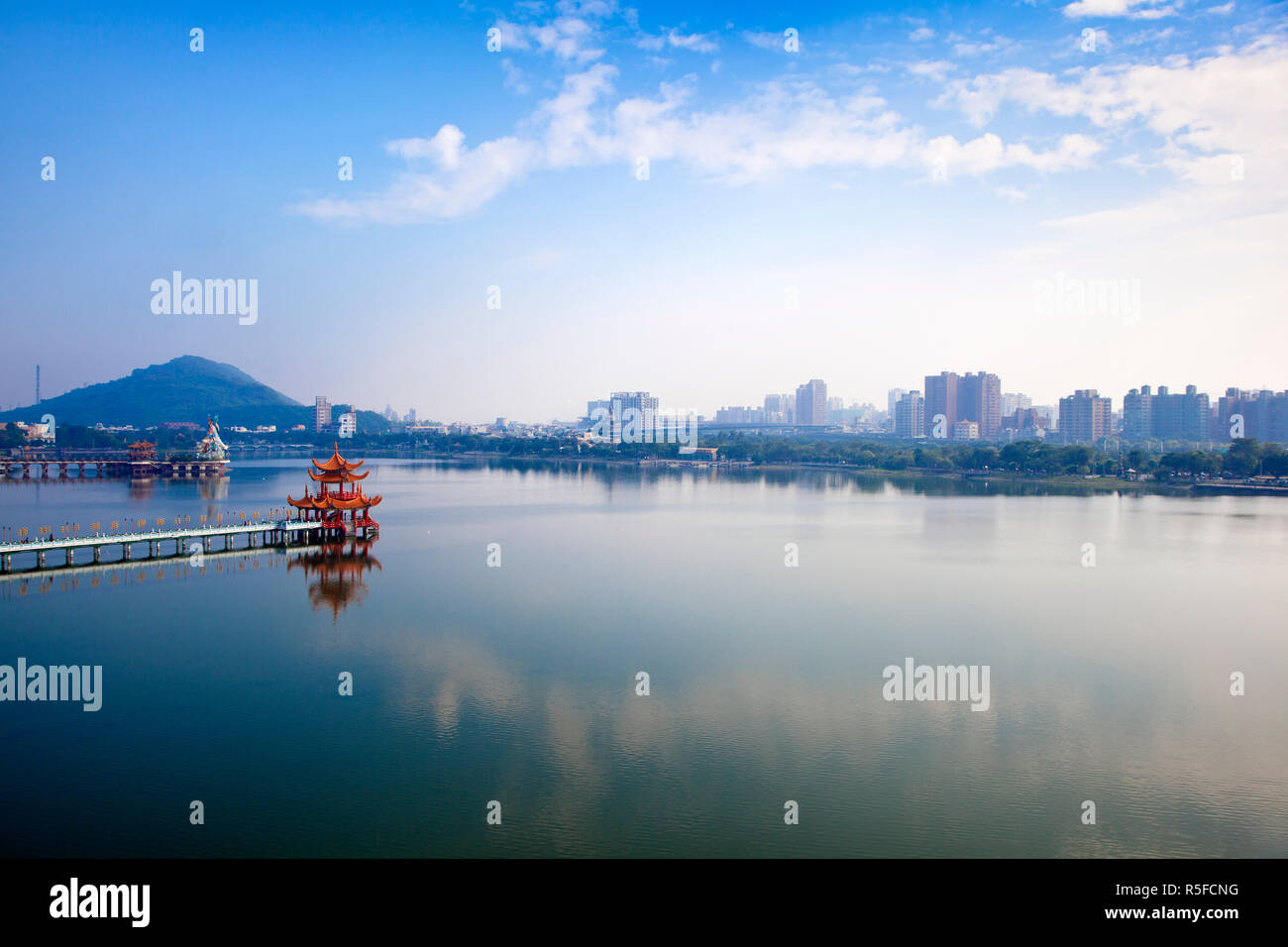 Taiwan, Kaohsiung, Lotus pond, View of bridge leading to Spring and Autumn pagodas with statue of Syuan Tian Emperor in background Stock Photo