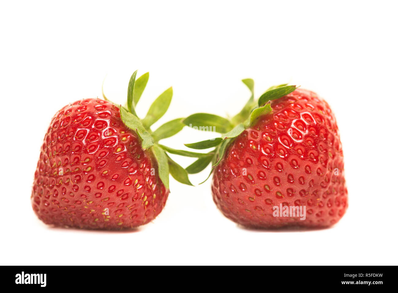 Two strawberries close-up isolated on a white background Stock Photo ...