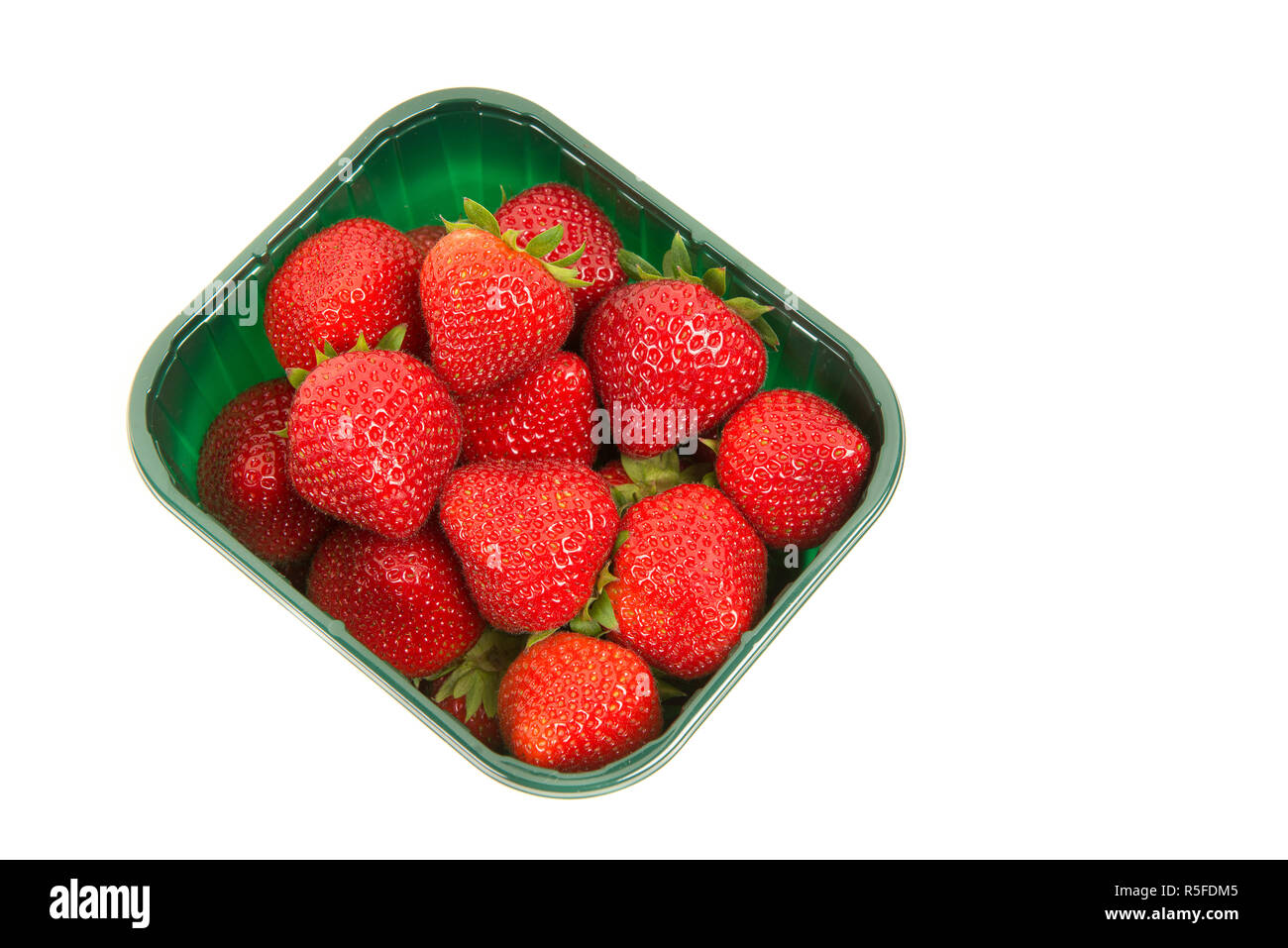 Strawberries in a green plastic box seen from above isolated on a white background Stock Photo
