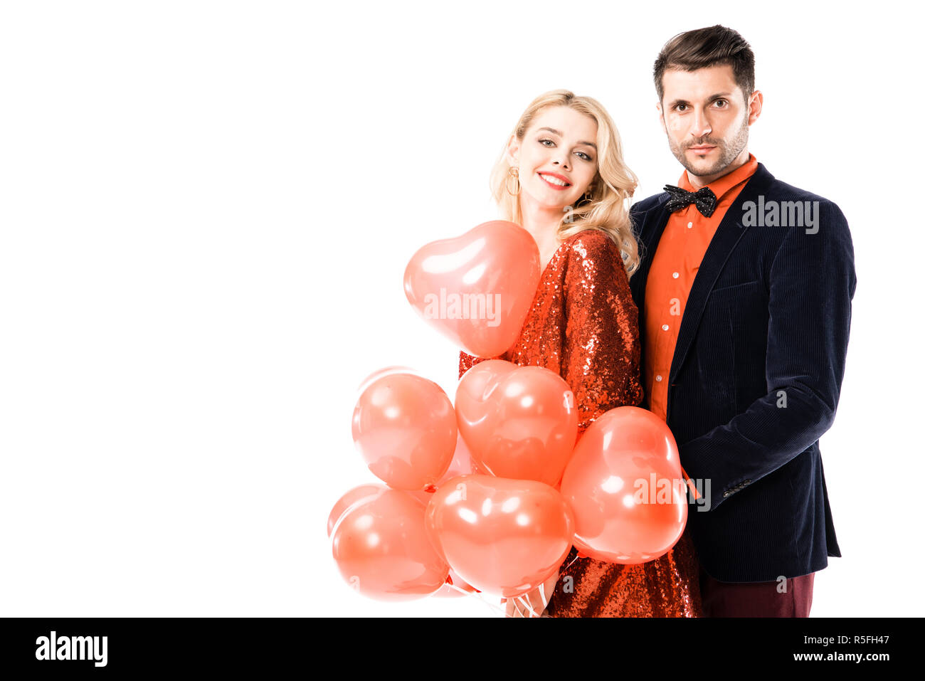 Attractive young couple with red balloons isolated on white Stock Photo ...