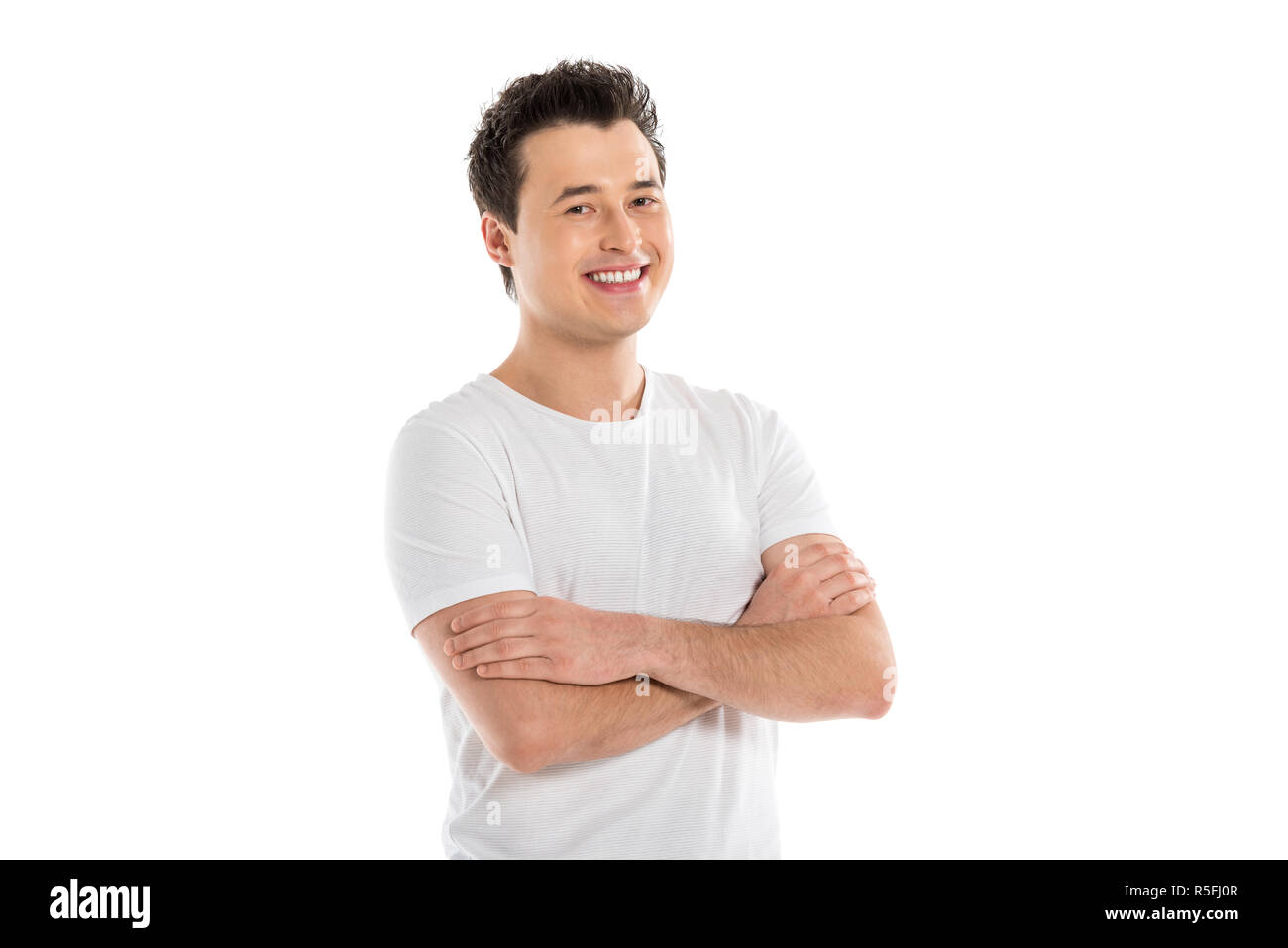 portrait of handsome smiling man with crossed arms looking at camera isolated on white Stock Photo