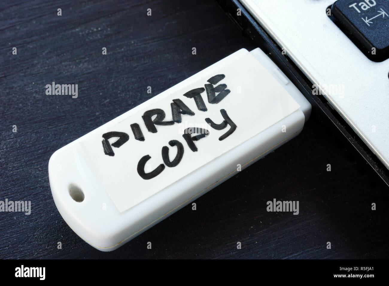 Pirate copy written on a flash drive. Copyright law. Stock Photo