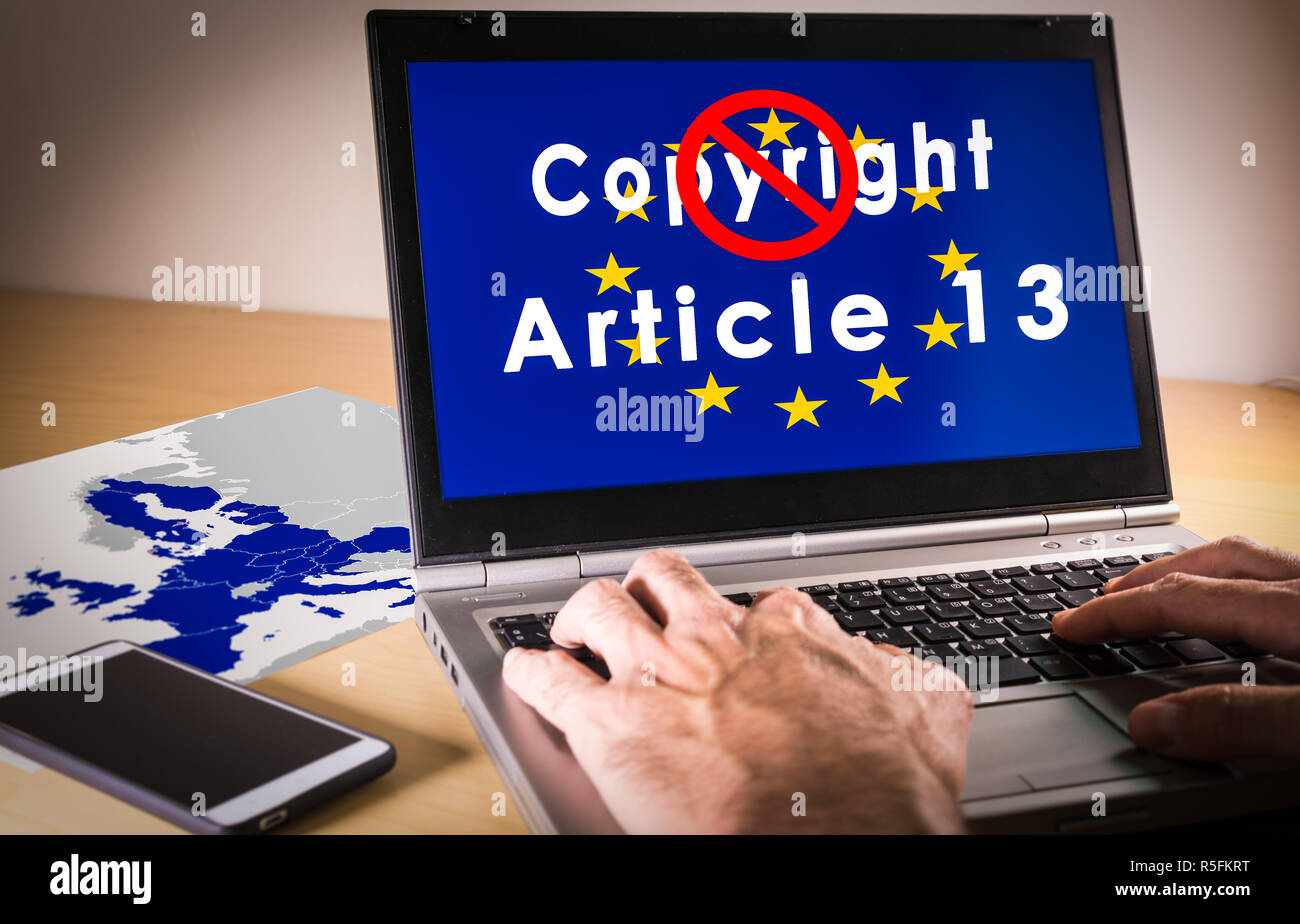 Laptop with eu flag, copyright and Article 13 words on screen Stock Photo