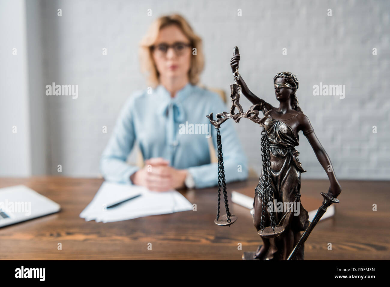 close-up view of lady justice statue and female lawyer working behind Stock Photo