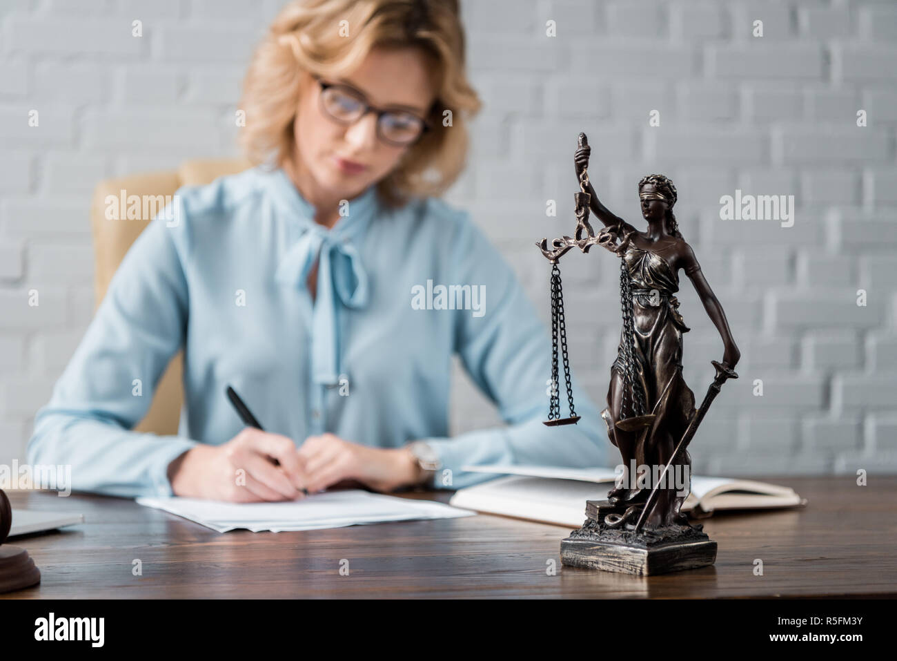 close-up view of lady justice statue and female lawyer working behind Stock Photo