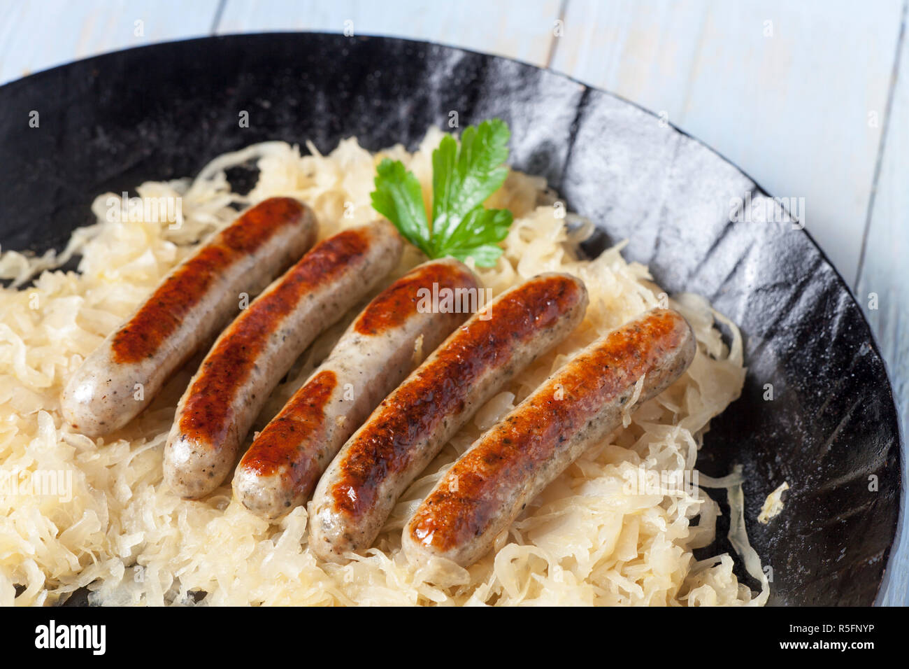 nuremberg bratwurst on cabbage in a pan Stock Photo
