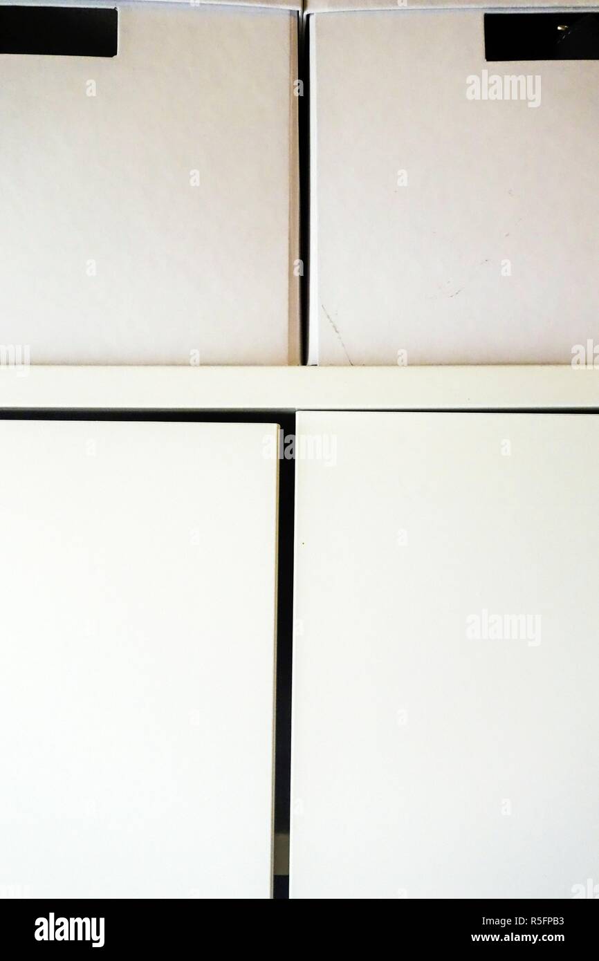 Two white storage boxes on top of a wardrobe Stock Photo Alamy