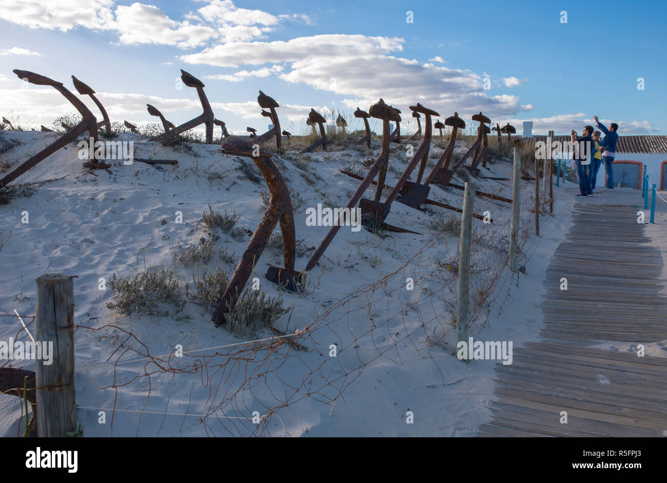 Tavira, Portugal - Oct 14th, 2018: Tourists taking pictures at Cemetery of Anchors. Memorial monument to dead fishermen of tuna industry in Portugal.  Stock Photo