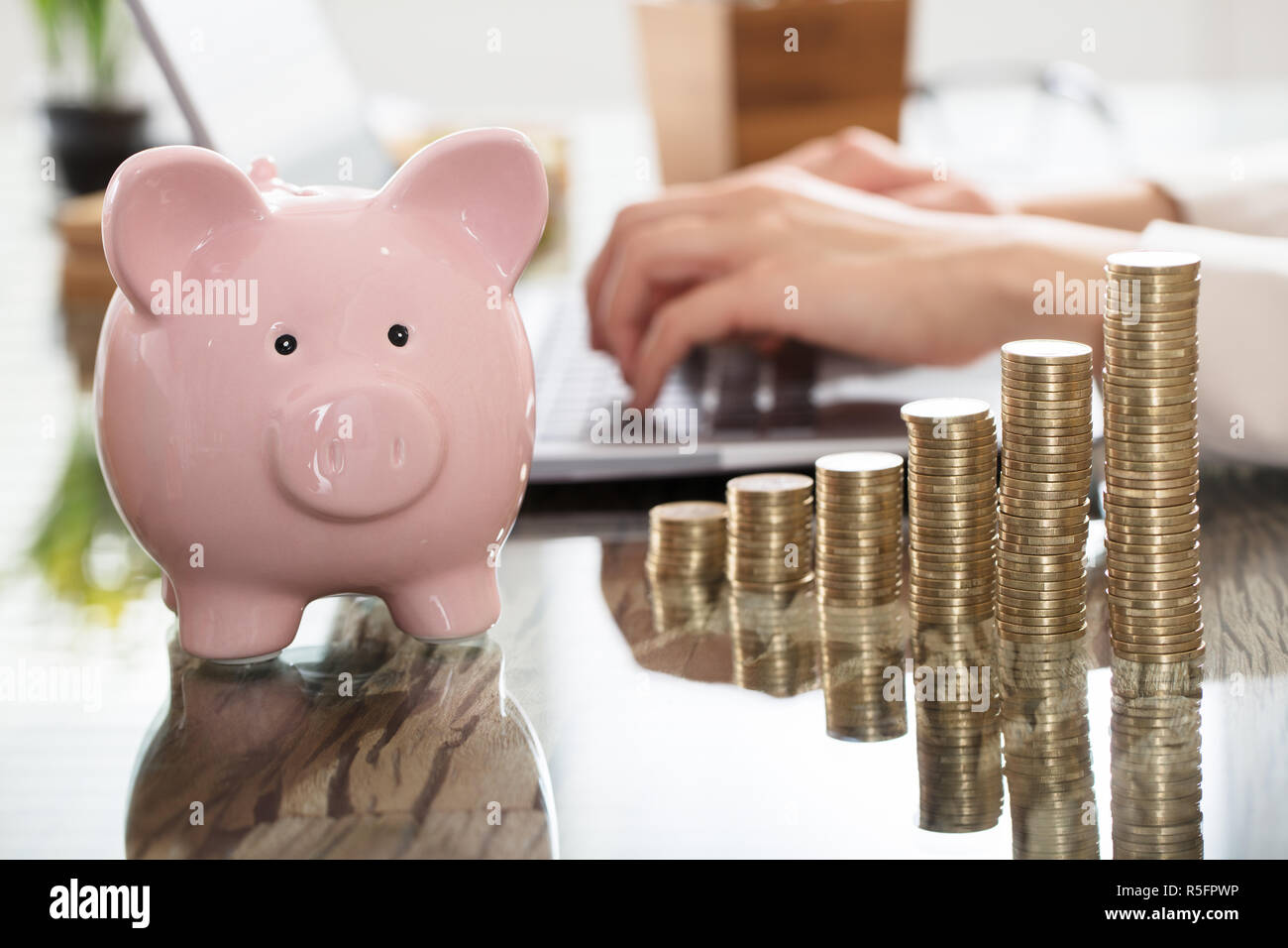 Piggy Bank And Increasing Coins Stack On Desk Stock Photo - Alamy
