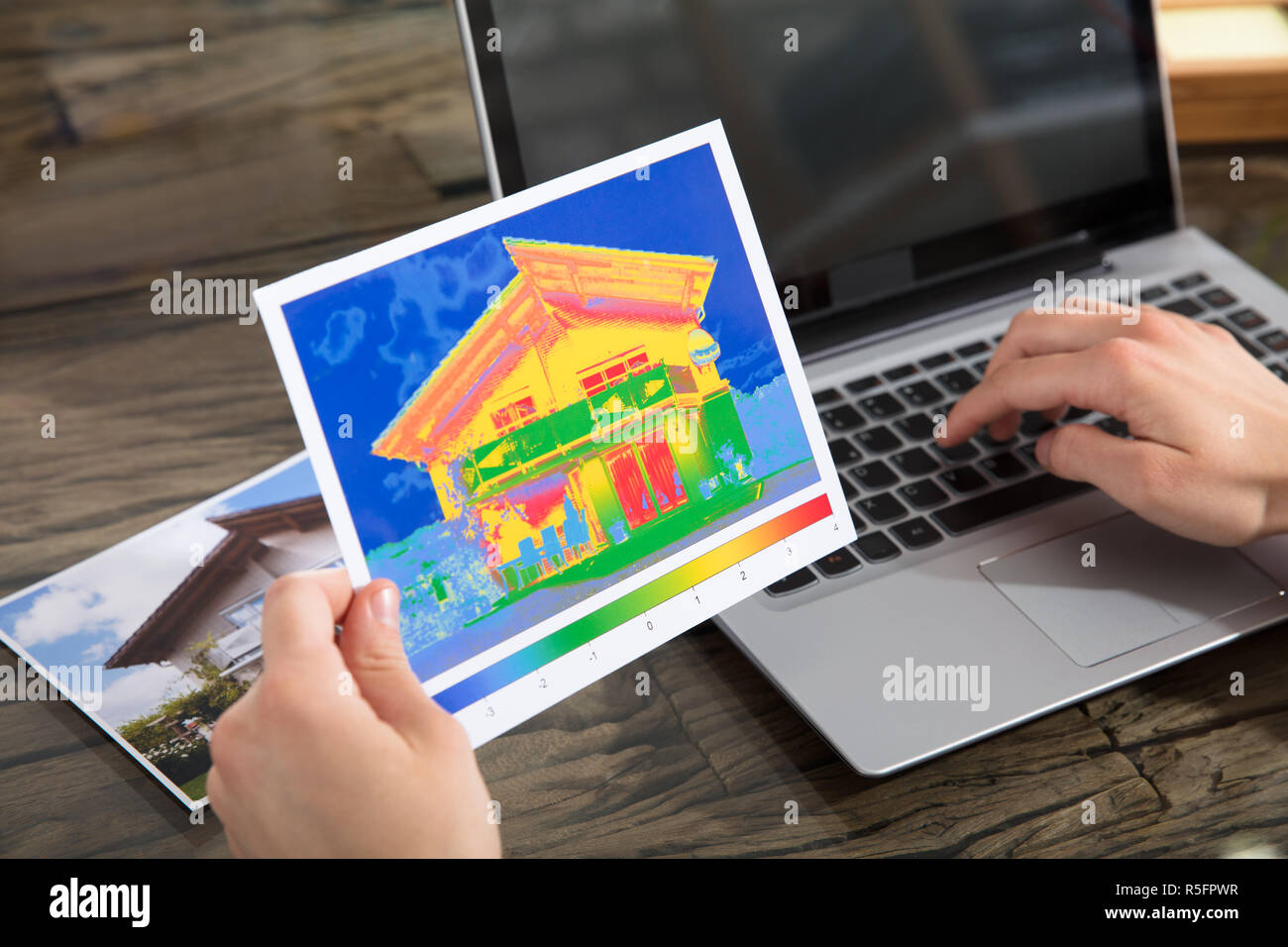 The Person Detecting Heat Loss Of A House Using Laptop Stock Photo Alamy