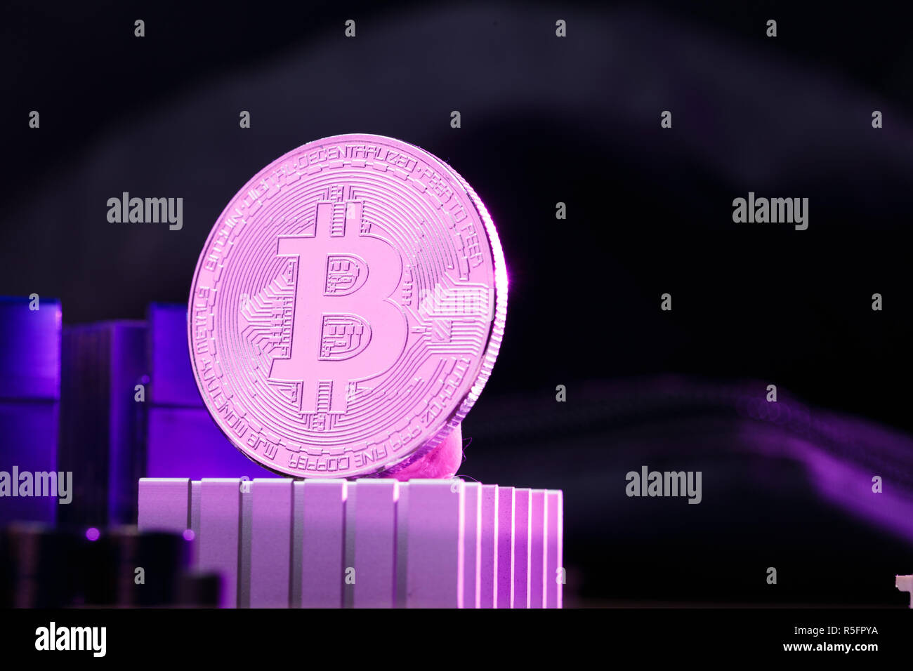 Image of virtual currency, bitcoin and processor on pink background Stock Photo