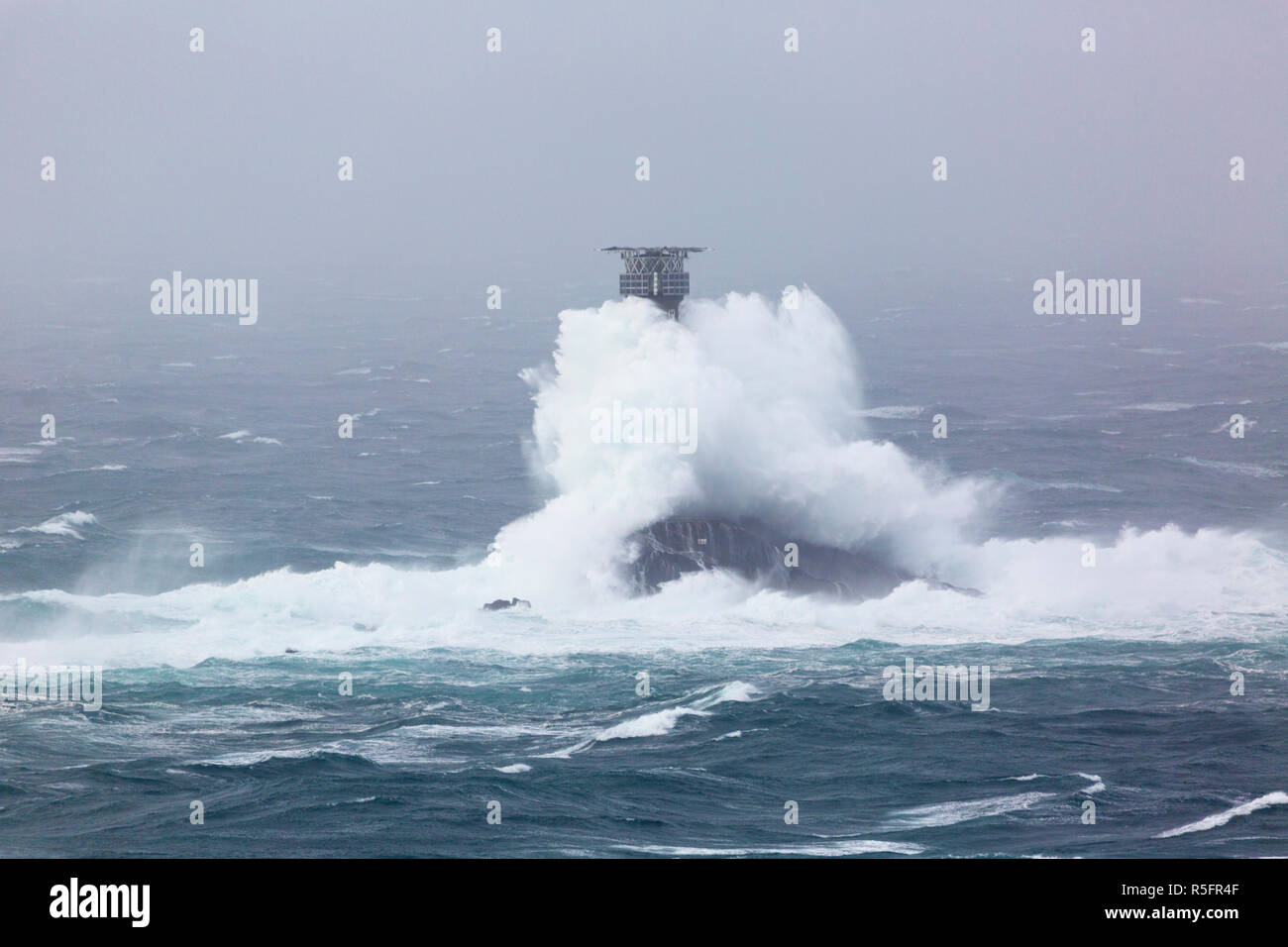 Storm Diana smashing into the Longships Lighthouse off Lands End Cornwall Stock Photo