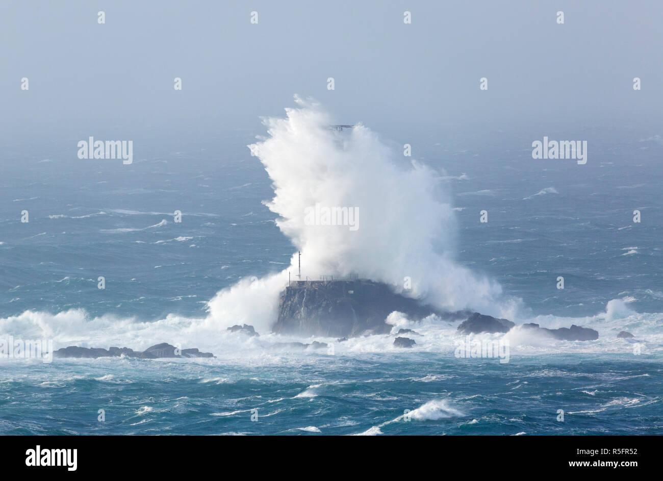 Storm Diana crashing into the Longships Lighthouse off the Cornish coast Stock Photo