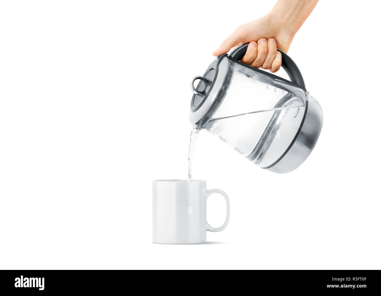 Blank white ceramic mug with hot teapot mock up, isolated, front view. Clear drink cup with teakettle mockup. Sensitive kitchen utensil in arm template. Brew beverage in thermal crockery. Stock Photo