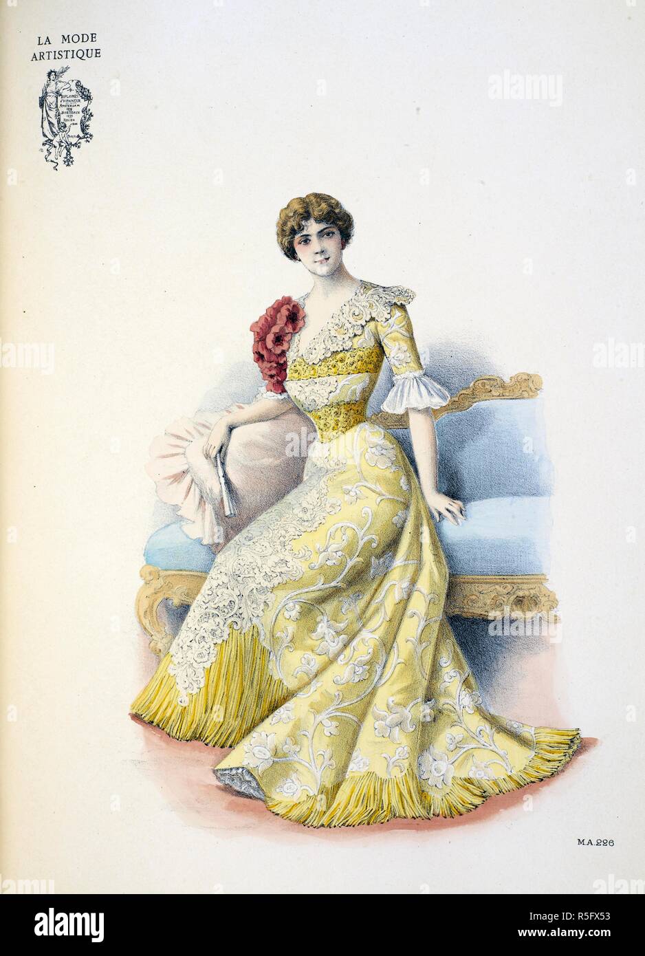 Gown created for Jane Hading by LaferriÃ¨re for her European tour. A costume of shot corn-coloured taffetas glacÃ© boacaded with a design in white velvet. Down the front of the skirt is a tablier of course string-coloured guipure underneath which flows a deep fringe of slik chenille, which edges the skirt at intervals around the hem.  The corsage is tight-fiting, the dÃ©colletage arranged with a collar and flat berthe of the lace guipure caught down by a wide strap of heavy gold passementerie embroidered i fine pearls. the same trimming is repeated at the waist. On the right sholuder is a bouq Stock Photo