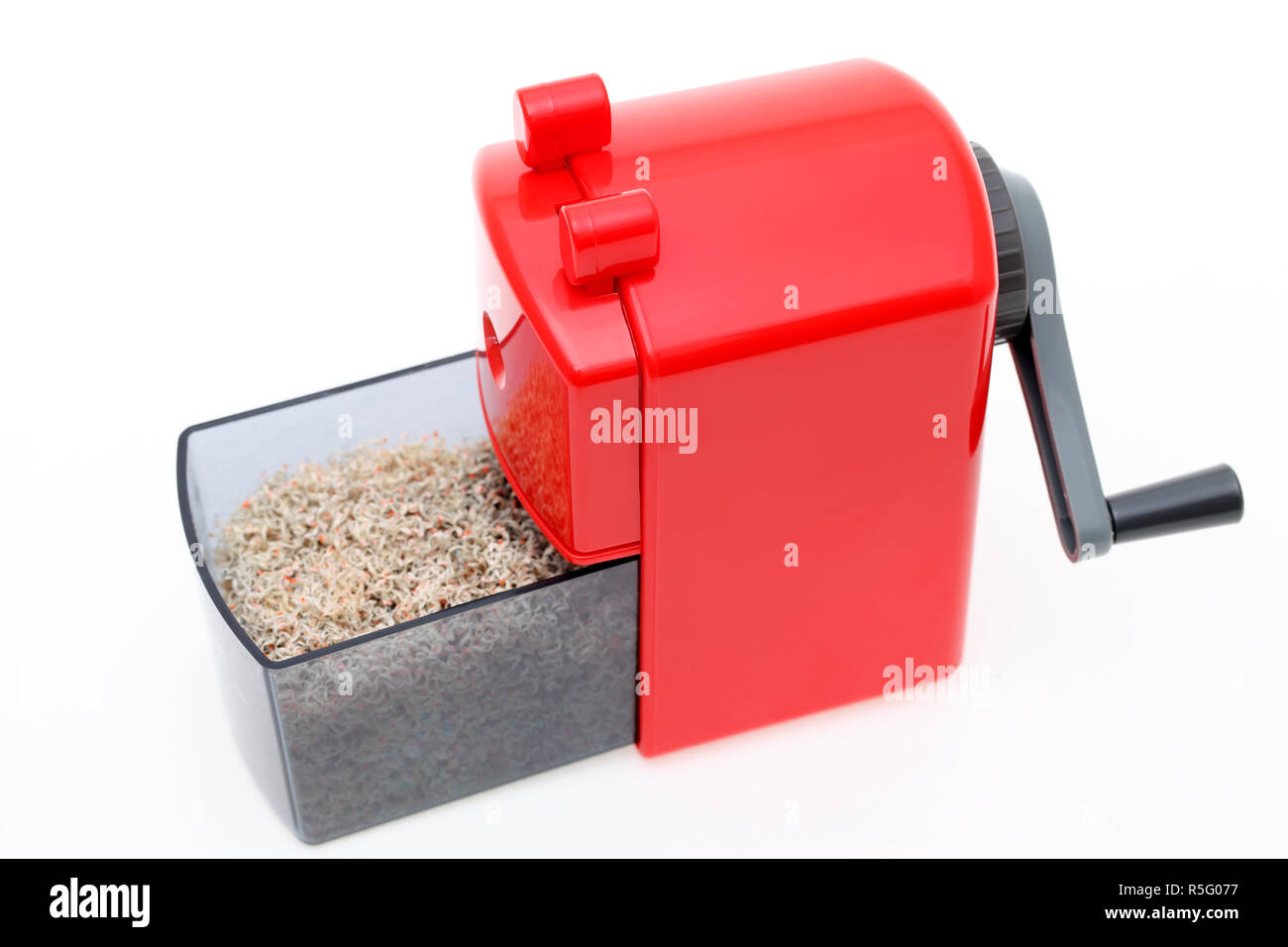 Red pencil sharpener with pencil trash on white background Stock Photo Alamy