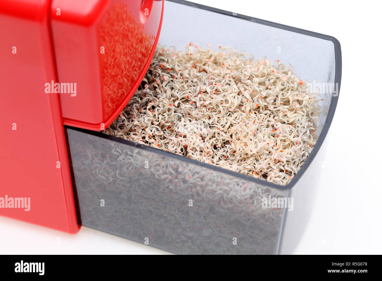 Red pencil sharpener with pencil trash on white background Stock Photo Alamy